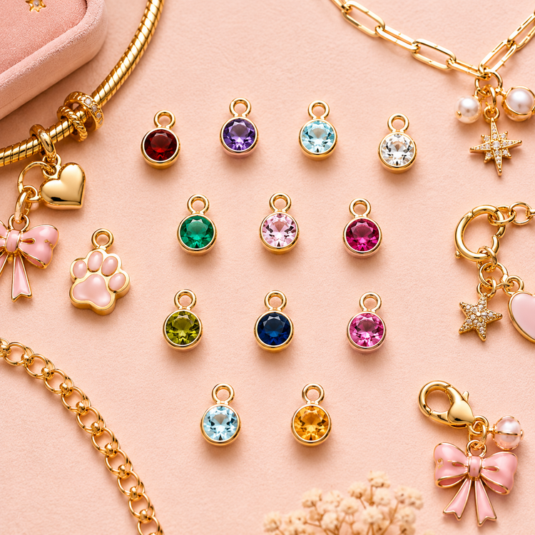 Birthstone charms for every month UK with a gold bracelet showing two birthstone charms