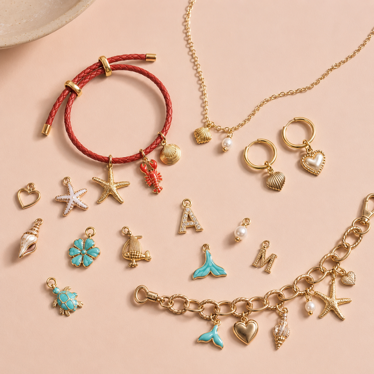 Build your own charm bracelet, necklace, earrings and bag chain UK with gold charm jewellery on a soft pink background
