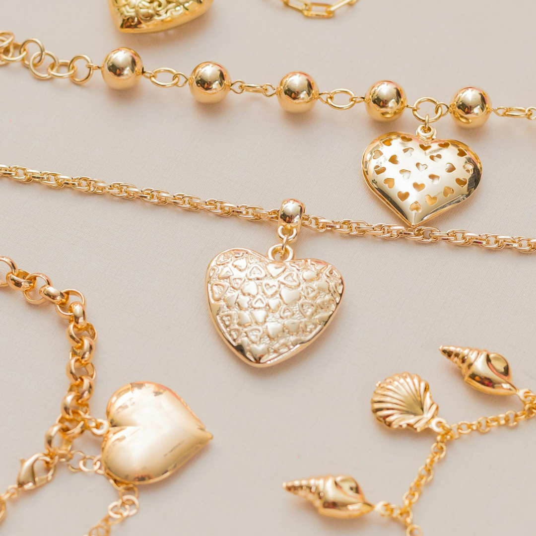 Loose gold charms in hearts, letters and animals from My Charm Bar