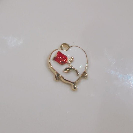 White heart charm with a red flower on a white background